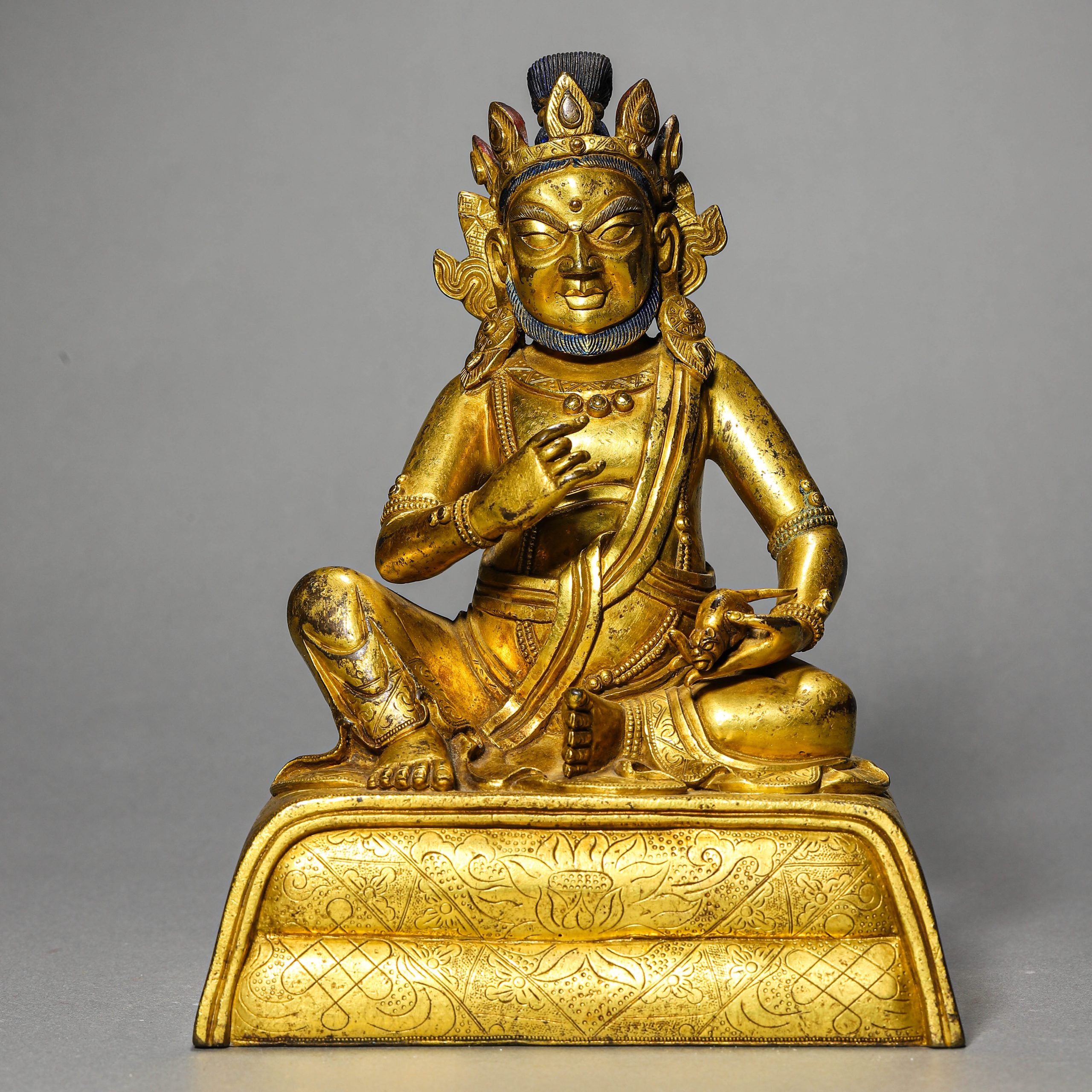 A CHINESE GILT BRONZE FIGURE OF JAMBHALA (YELLOW CAISHEN), POSSIBLY QING DYNASTY, 18TH–19TH CENTURY.