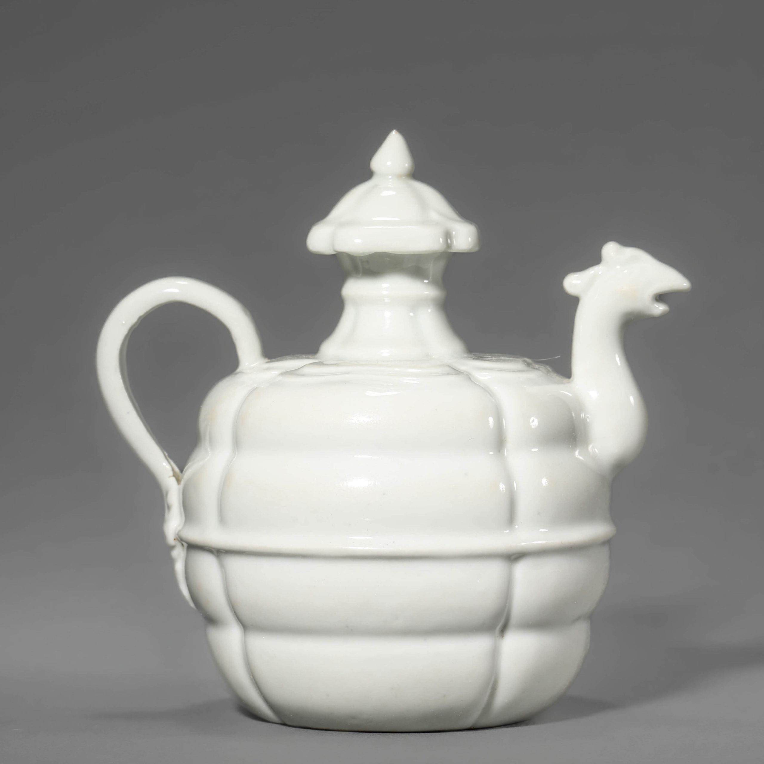 A CHINESE EARLIER SONG DYNASTY WHITE-GLAZED PHOENIX SPOUT VESSEL, POSSIBLY 10TH CENTURY OR EARLIER.