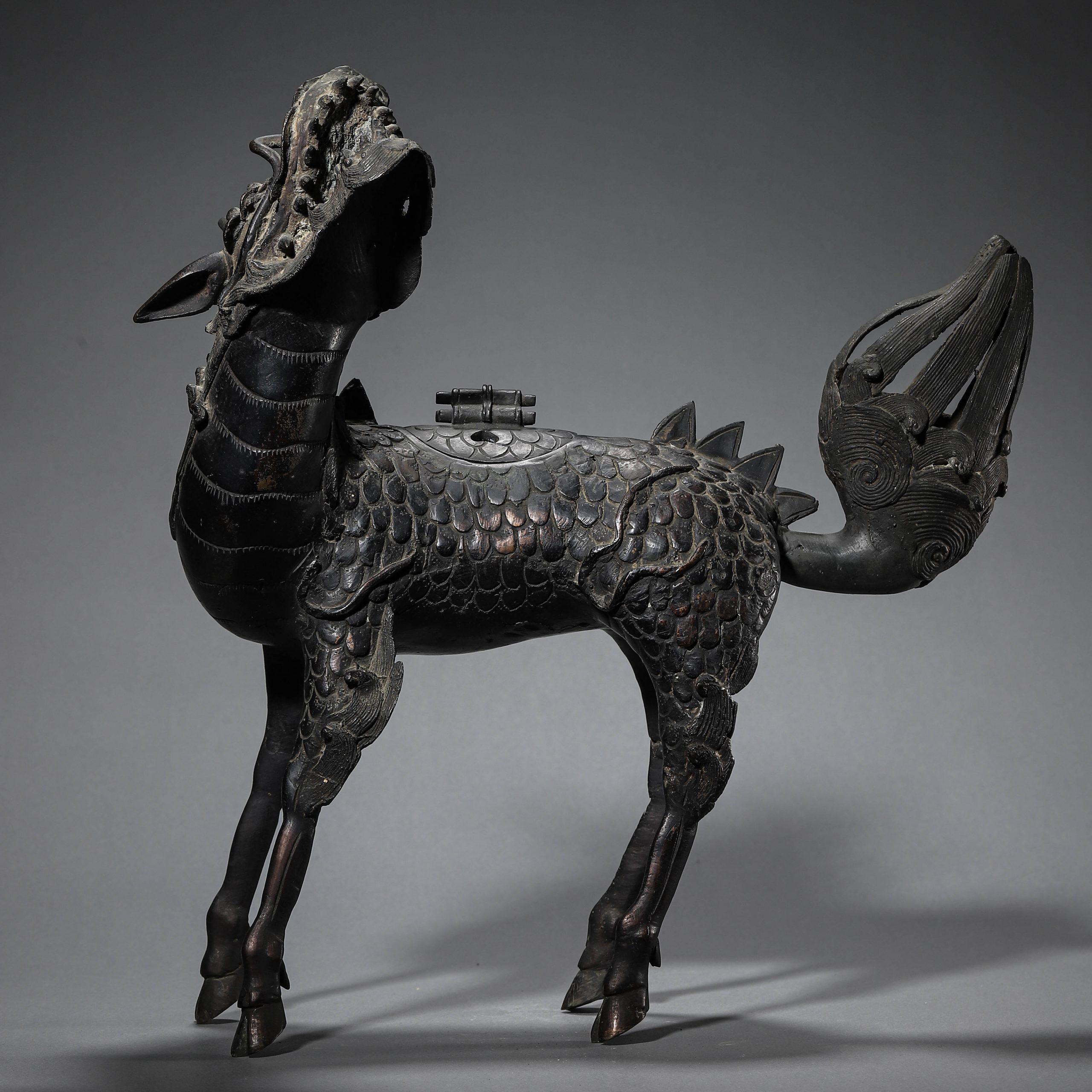A CHINESE BRONZE INCENSE BURNER IN THE FORM OF A KIRIN.
